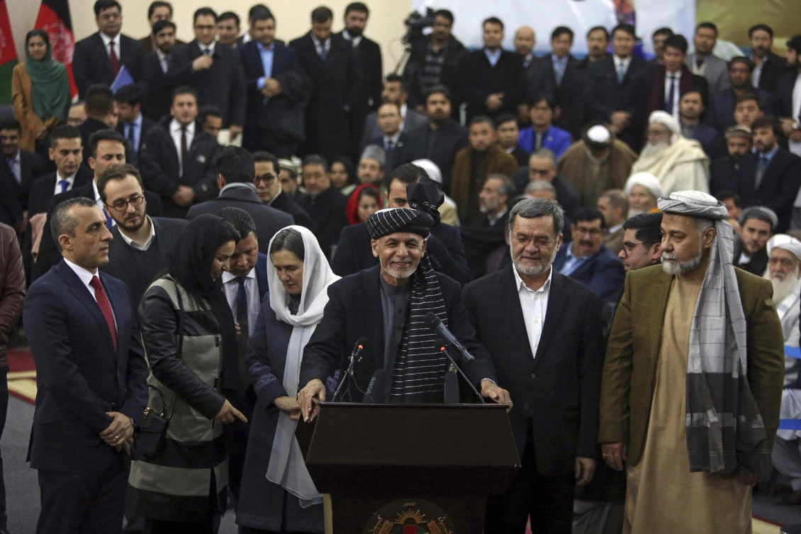 Afghanistan’s President Ashraf Ghani, center, addresses a crowd after arriving to register as a candidate for the presidential election in Kabul on Sunday, January 20. (AP)