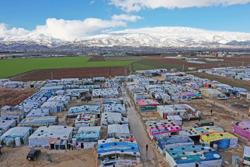 An aerial view shows an informal tent settlement housing Syrian refugees in the area of Delhamiyeh, in the central Bekaa Valley, Lebanon, on January 17, 2019. (AFP / JOSEPH EID)