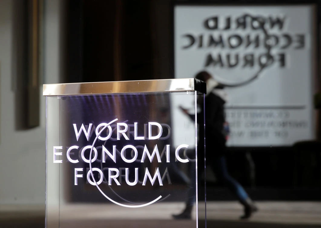 A person passes by a World Economic Forum logo in Davos, Switzerland, January 20, 2019. (Reuters/Arnd Wiegmann)