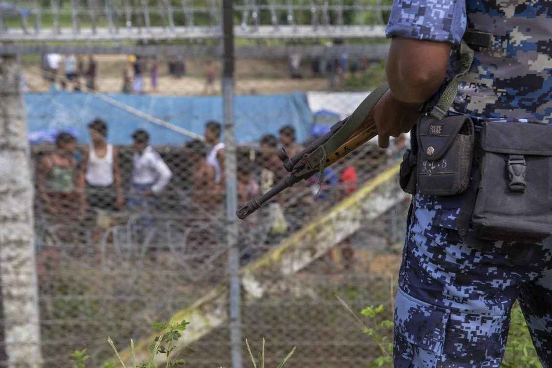 Myanmar border guard police patrol the fence in the "no man's land" zone between Myanmar and Bangladesh border as seen from Maungdaw, Rakhine state during a government-organized visit for journalists on August 24, 2018. (AFP)