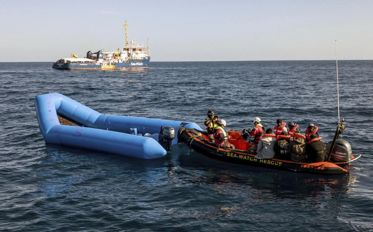 In this photo taken on Saturday, Jan. 19, 2019, a Sea-Watch ship approaches a dinghy boat to rescue migrants in the Mediterranean Sea. (AP)