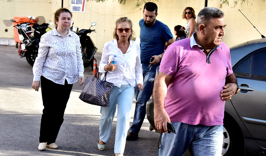 Turkish journalist Nazli Ilicak (C), also a well-known commentator and former parliamentarian, is escorted by a police officer (R) and her relatives (L and rear) after being detained and brought to a hospital for a medical check in Bodrum, Turkey. (Reuters/File)