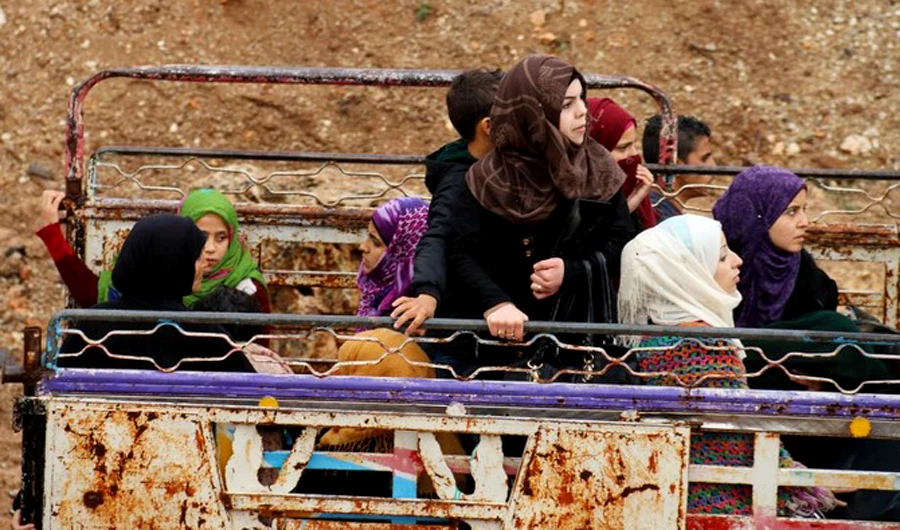 Photo showing Syrians gather at a departure point prior to being evacuated from the rebel-held town of Rastan, in Syria’s central Homs province, in a convoy of buses, Rastan, Homs, May 7, 2018. (AFP/File)