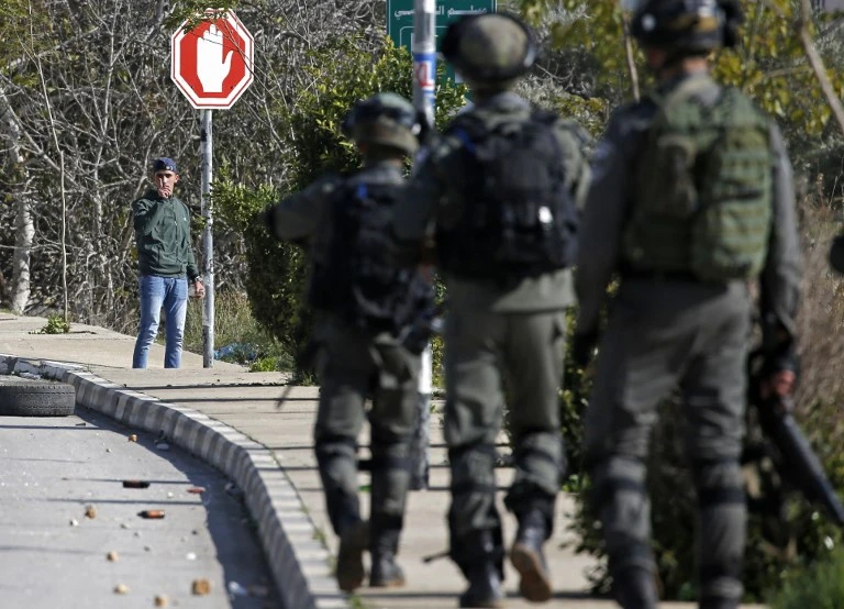 Palestinian youths challenge Israeli soldiers during clashes in the West Bank city of Ramallah following a raid on December 10, 2018. (File/AFP)