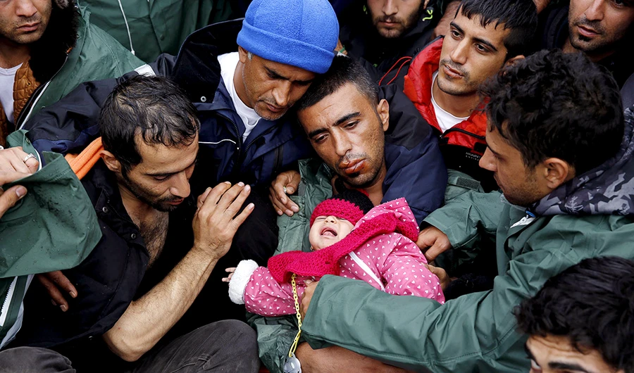 Stranded Iranians at the border between Greece and Macedonia. (Reuters)