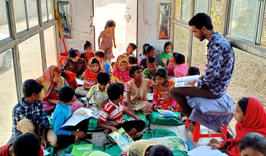 Students taking classes in a mobile school bus at Mirpur, Dhaka. (AN photo)