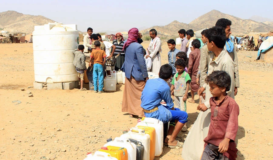 Yemenis who fled fighting between government forces and Iran-linked Shiite Houthi fighters in Hodeida fill water jerricans at a camp for displaced people in the northern district of Yemen's Hajjah province on January 16, 2019. Heavy fighting was reported around Hodeidah again on Jan. 24, 2019. (AFP)