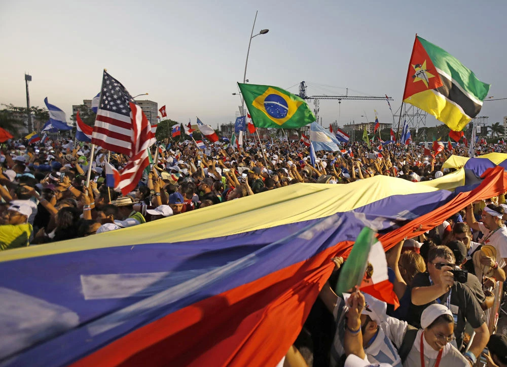 Thousands of pilgrims wave their national flags as Pope Francis arrives for a welcoming ceremony to open his participation in the church's World Youth Day festivities in Panama City onJan. 24, 2019. (AP Photo/Rebecca Blackwell)