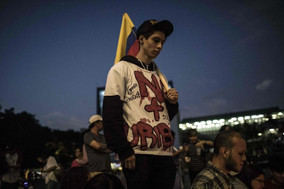 A Colombian youth takes part in a demonstration demanding efforts to continue the peace talks between the government and the ELN guerrillas on January 25, 2019. (AFP)