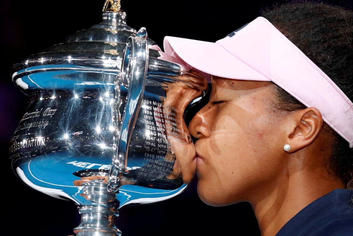 Japan's Naomi Osaka kisses her trophy after winning her Australian Open final match against Czech Republic's Petra Kvitova. (Reuters)