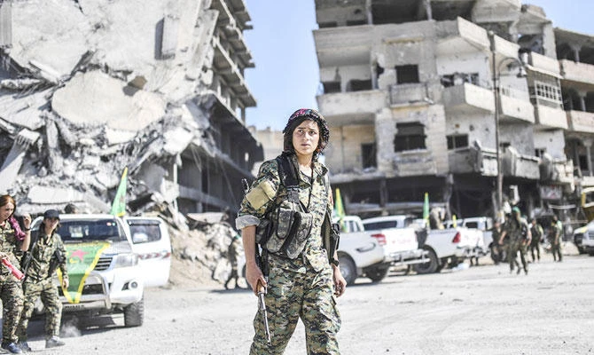 Kurdish fighters of the Syrian Democratic Forces gather in Raqqa, shortly after retaking it from Daesh. (AFP)