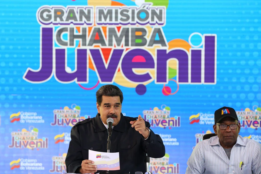 Handout picture released by the Venezuelan presidency showing Venezuelan President Nicolas Maduro (L) speaking during a television program in Caracas on January 26, 2019. (Venezuelan presidency handout via AFP)