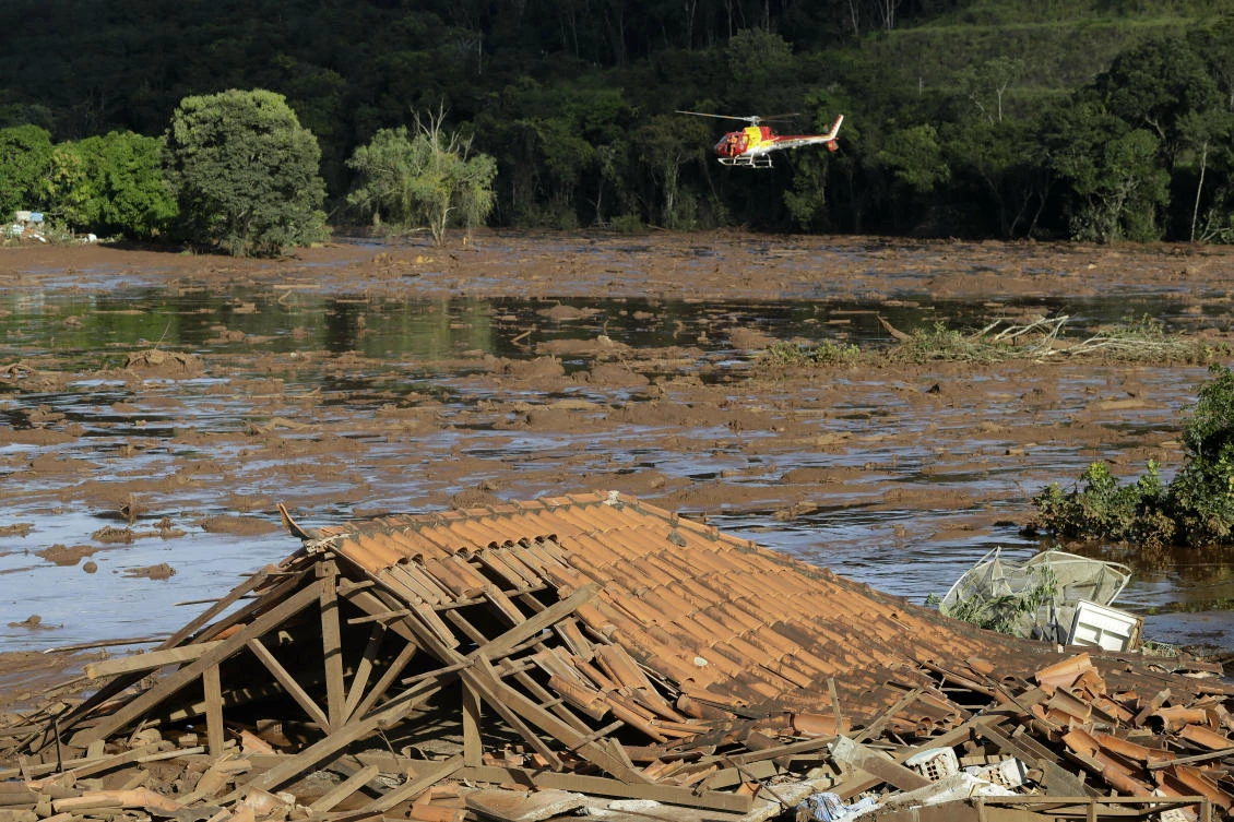 Rescue crews aboard a helicopter search a flooded area after a dam collapsed in Brumadinho, Brazil. (AP)