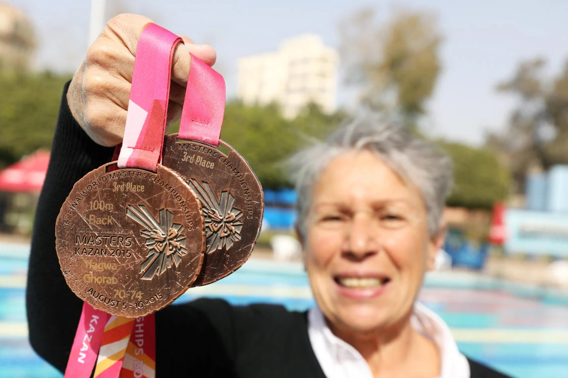 Egyptian swimmer Nagwa Ghorab, 76, shows her medals after her training session in Cairo, Egypt January 27, 2019. Picture taken January 27, 2019. (Reuters)