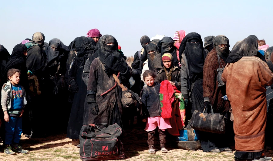 Civilians gather at a Syrian Democratic Forces outpost near the frontline village of Baghouz, on Jan. 26 ahead of being screened and registered by the SDF. (AFP)