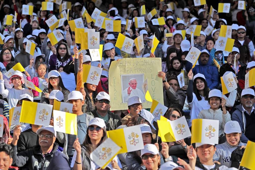 - Christian worshippers attend a mass, led by Pope Francis, at the Zayed Sports City Stadium. (AFP)