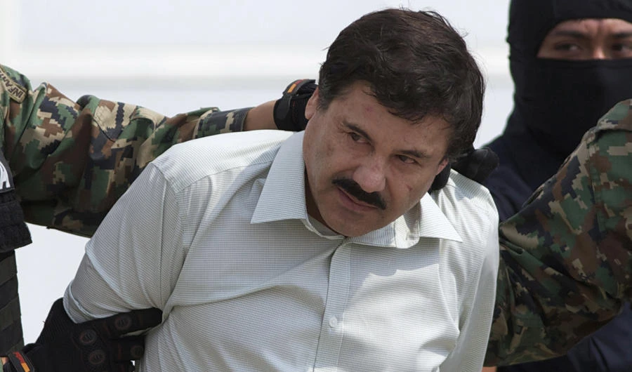 This Feb. 22, 2014 file photo shows Joaquin "El Chapo" Guzman, the head of Mexico's Sinaloa Cartel, being escorted to a helicopter in Mexico City following his capture in the beach resort town of Mazatlan. (AP Photo/Eduardo Verdugo, File)