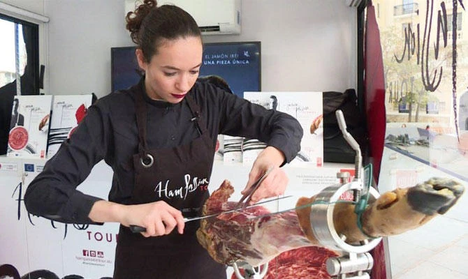 In Spain, cutting "jamon" is a fully-fledged job that brings prestige and money, a man's world which women are only just starting to take on. (AFP)