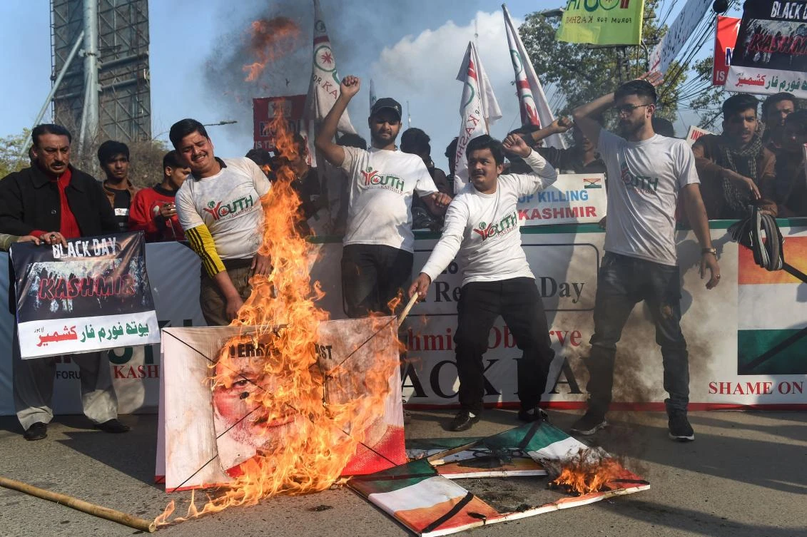 Pakistani students burn a portrait of Indian Prime Minister Narendra Modi during an anti-India demonstration and in support of Kashmir, a region disputed between India and Pakistan, in Lahore on January 26, 2019. (AFP)
