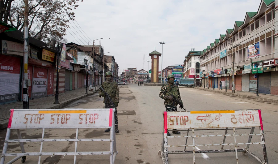 Indian paramilitary soldiers stand guard near a temporary checkpoint during a strike in Srinagar, Indian-controlled Kashmir, on Feb. 3, 2019. (AP Photo/Dar Yasin)