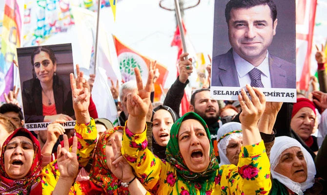 Supporters of the pro-Kurdish Peoples' Democratic Party (HDP) hold a picture of jailed former party leader Selahattin Demirtas as they attend a 'Peace and Justice' rally in Istanbul on February 3, 2019. (AFP)
