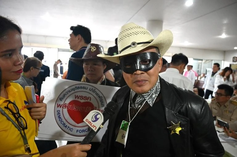 Noppajun Woratitwuttikul, a representative of Palang Prachatipatai Party, arrives for registration with the election commission wearing a Lone Ranger costume in Bangkok. (AFP)
