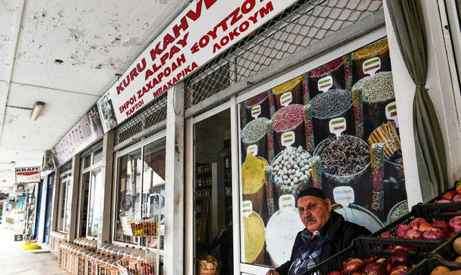 A man sits outside his shop in the old market of Komotini, northeastern Greece, on the eve of the Greek's Prime Minister's official visit to Turkey, on February 4, 2019. (AFP)
