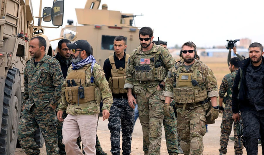 Syrian Democratic Forces and US troops during a patrol near Turkish border in Hasakah. (Reuters/File)
