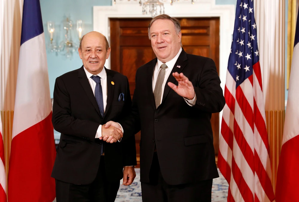 Mike Pompeo, right, and French Foreign Minister Jean-Yves Le Drian during a gathering of foreign ministers aligned toward the defeat of Daesh at the State Department in Washington. (Reuters)