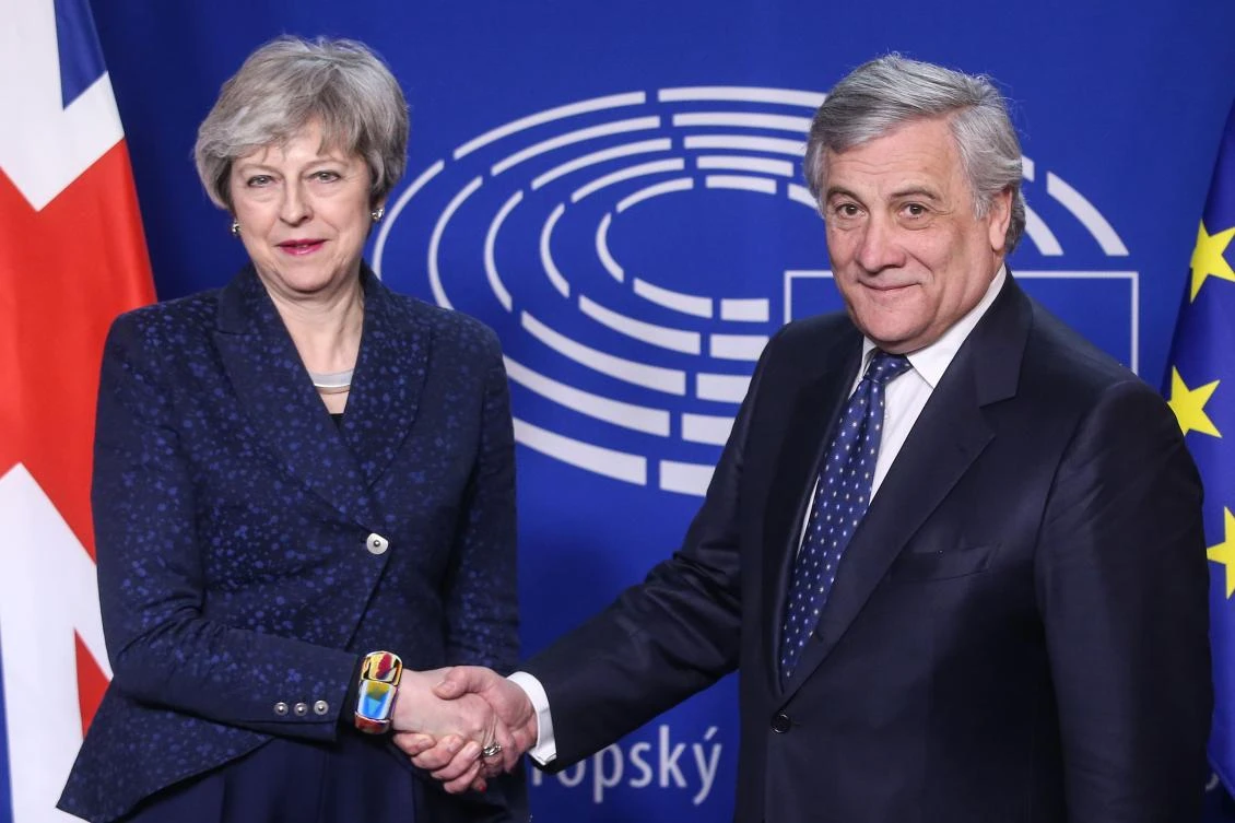 European Parliament President Antonio Tajani shakes hand with British Prime Minister Theresa May before a meeting at the European Parliament on February 7, 2019 in Brussels. (AFP)