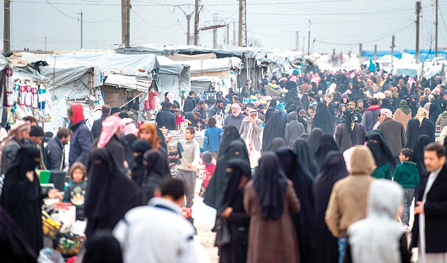 Displaced Syrians, including families of militants, at the internally displaced persons camp of Al-Hol in Al-Hasakeh governorate in northeastern Syria on Wednesday. (AFP)