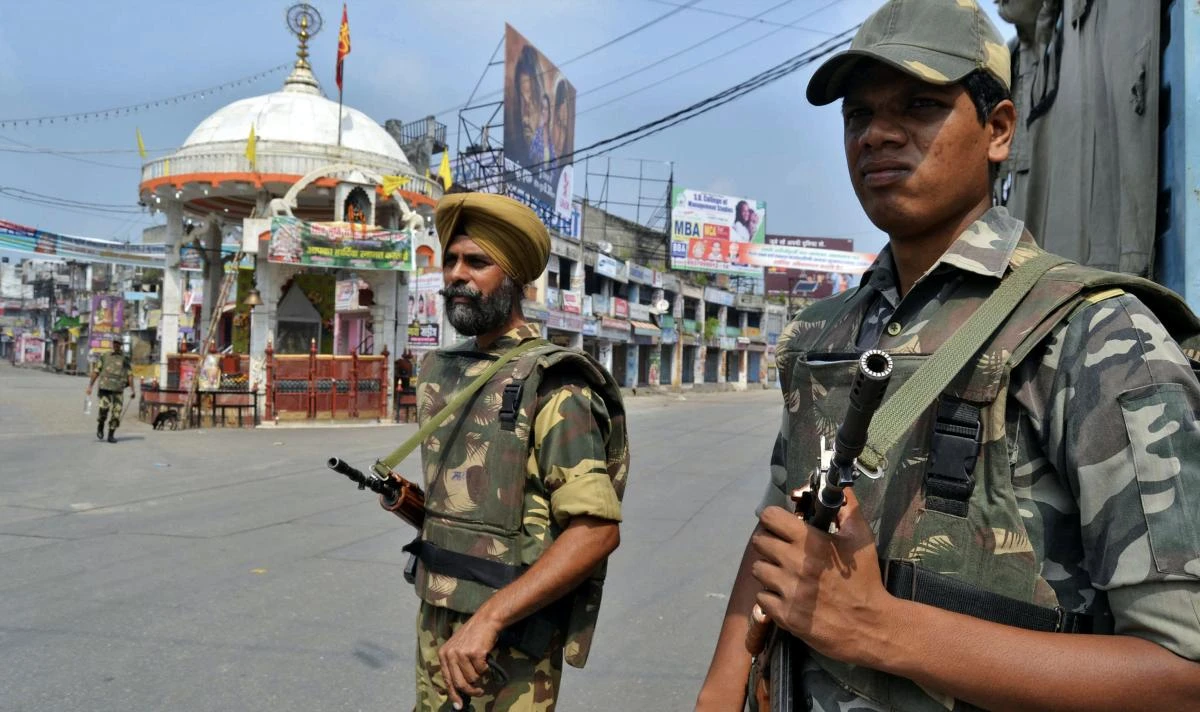 In this file photo, soldiers stand guard on a deserted street during a curfew in Muzaffarnagar, 127 km (80 miles) northeast of New Delhi, in the state of Uttar Pradesh. (Reuters)