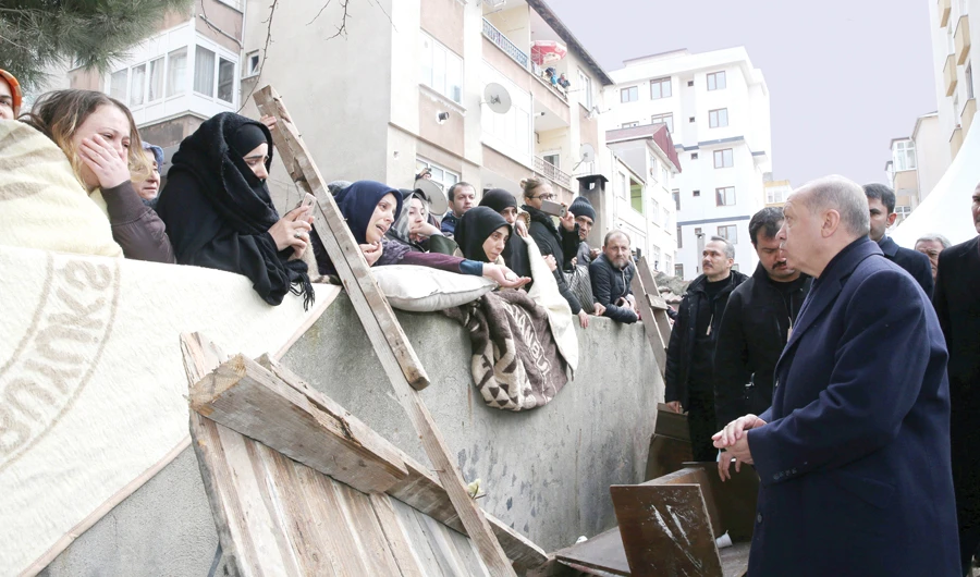 Turkish President Tayyip Erdogan talks to residents as he visits the site of a collapsed building in Istanbul, on Saturday. (Reuters)