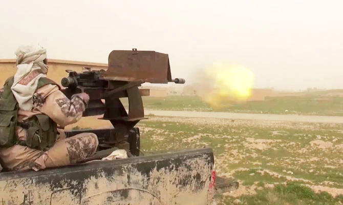 This frame grab from video posted online Jan. 18, 2019, by supporters of the Daesh group, purports to show a gun-mounted Daesh vehicle firing at members of the U.S.-backed Syrian Democratic Forces, in the eastern Syrian province of Deir el-Zour, Syria. (AP)