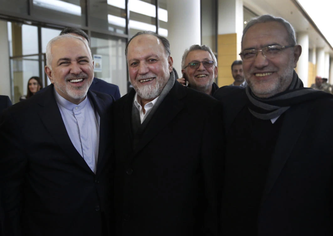 Iran's Foreign Minister Mohammad Javad Zarif, left, poses for a picture with Hezbollah lawmaker Ali Ammar, center, and Lebanese Minister of State Parliamentary Affairs Mahmoud Qmati, right, on his arrival at Rafik Hariri Airport, in Beirut, Lebanon, Sunday, Feb. 10, 2019. (AP)