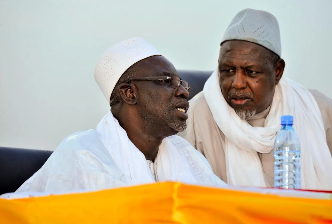 In this file photo taken on May 2, 2015 Malian religious leader Cherif Ousmane Madani Haidara (L) speaks to Mahmoud Dicko, the head of Mali's High Islamic Council (HCIM), during a peace gathering organised by non-governmental organisations in Bamako following deadly clashes between Tuareg rebel groups and Malian forces and pro-government militias in the north of the country. (AFP)