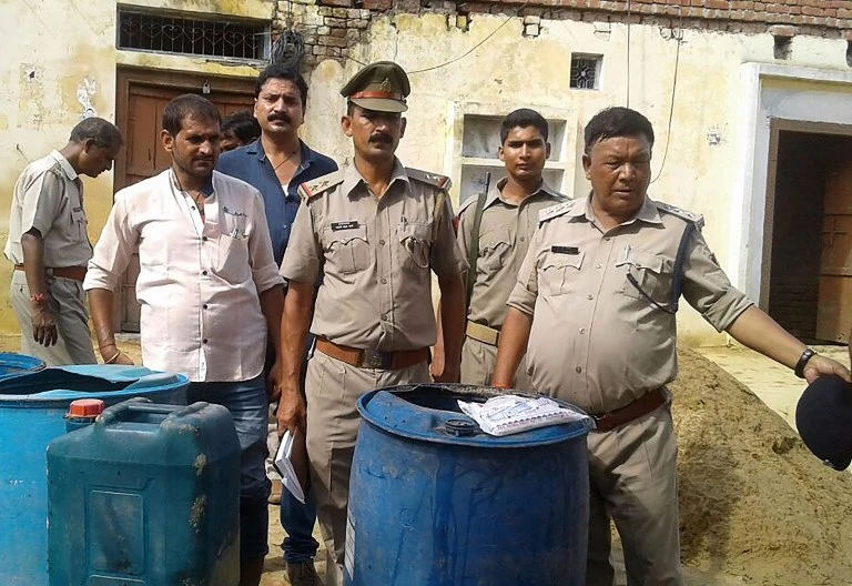 Police spokesman said 59 people died in one of the districts in Uttar Pradesh after ingesting the toxic alcohol. Above, police raid an illegal alcohol manufacturer in Uttar Pradesh state after dozens of people died after ingesting toxic alcohol. (AFP)