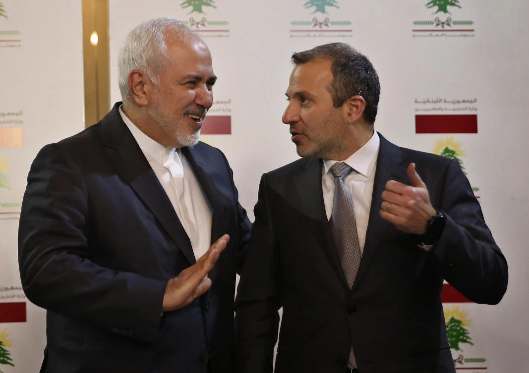 Lebanese Foreign Minister Gebran Bassil, right, speaks with his Iranian counterpart Mohammad Javad Zarif, in Beirut. (AP)