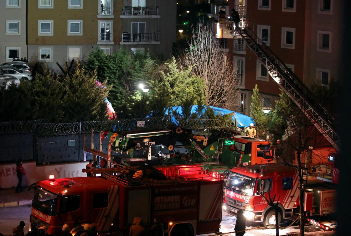 Fire fighters and police inspect the site of a helicopter crash in Istanbul. (Reuters)
