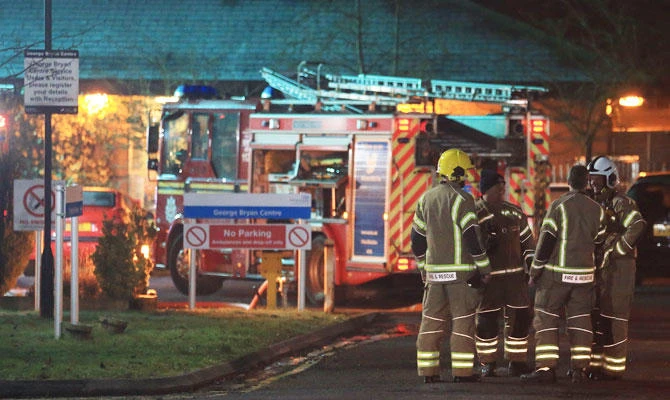 Firefighters work at the scene of a fire at George Bryan Centre at the Sir Robert Peel Hospital in Tamworth, central England, on February 11, 2019. (AFP)
