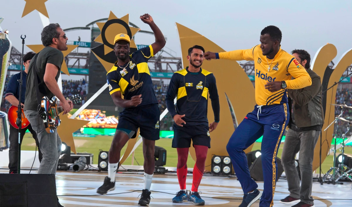 In this March 25, 2018 file photo, West Indies cricketers Darren Sammy, right, Andre Fletcher, second left, and Pakistani cricketer Hassan Ali, center, dance during a music show prior to start of the Pakistan Super League final cricket match at National stadium, in Karachi, Pakistan. (AP)