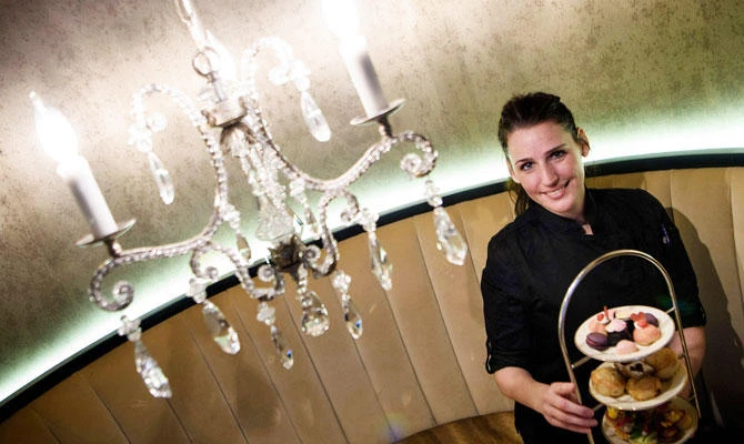 Head pastry chef Heather Dobson poses with food for Galentine's Day tea at the St. Regis hotel on February 12, 2019 in Washington, DC. (AFP)