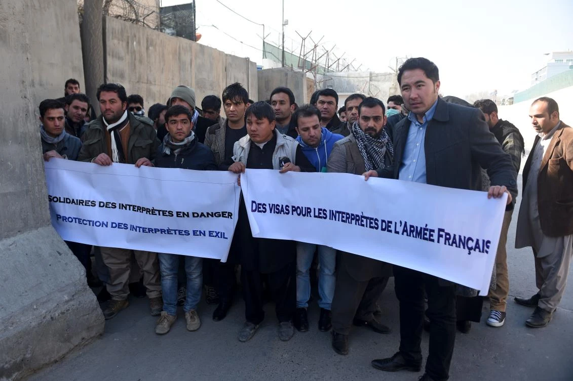 Afghan former interpreters for the French army hold banners during a demonstration demanding French visas outside of the French Embassy in Kabul. (AFP)