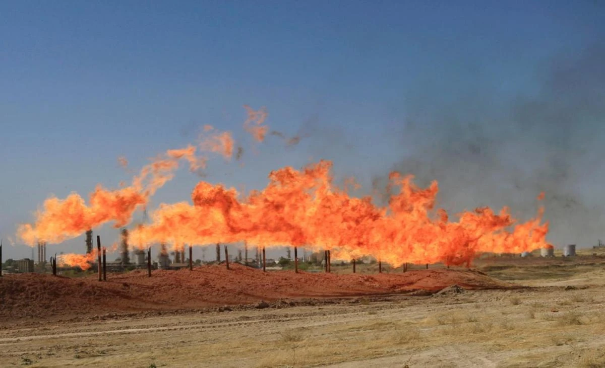 OPEC and its allies started voluntary production cuts last month, aiming to tighten the market. Above, flames emerge from flare stacks at oil fields in Kirkuk, Iraq. (Reuters)