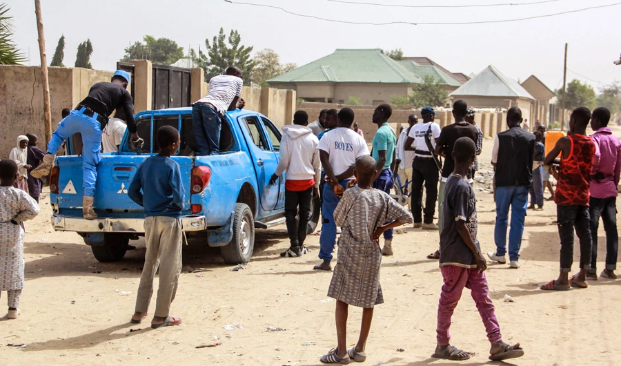 Members of the Civilian Joint Task Force (CJTF) inspect a street of the Jiddari Polo neighbourhood of the northeastern Nigeria city of Maiduguri, on Feb. 16, 2019 where Boko Haram fighters shot residents while two suicide bombers blew themselves up, killing eight people. (AFP)