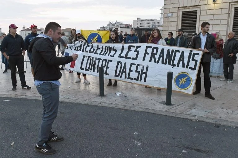 Above, activists hold a banner reading ‘Protect the French against Daesh’ near a makeshift memorial set-up on October 2, 2017 in Marseille. French government policy had been to categorically refuse to take back Daesh fighters and their wives. (AFP)