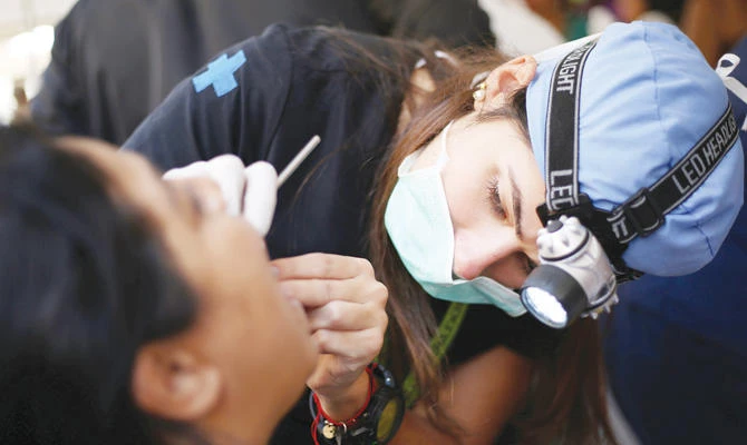 A dentist at a medical camp set up by volunteers in Caracas on Sunday. (Reuters)