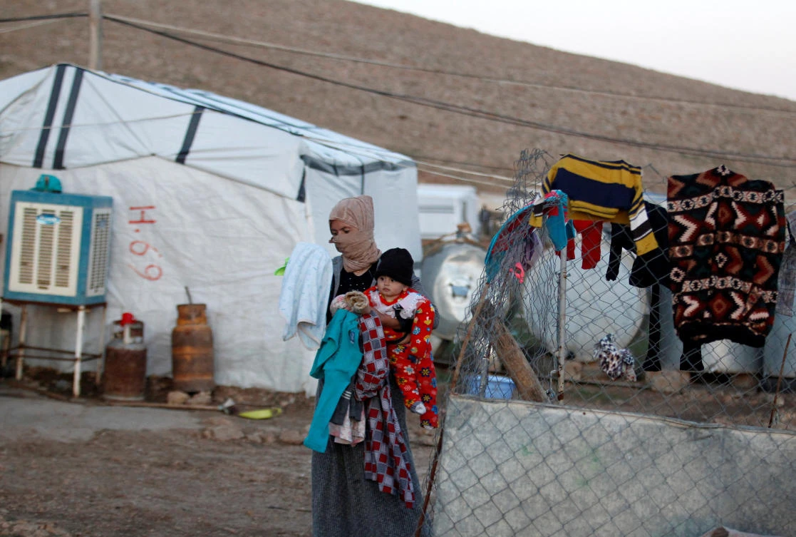 A Yazidi woman holds her baby at a refugee camp in Mount Sinjar, Iraq February 4, 2019. Picture taken February 4, 2019. REUTERS/Khalid al-Mousily