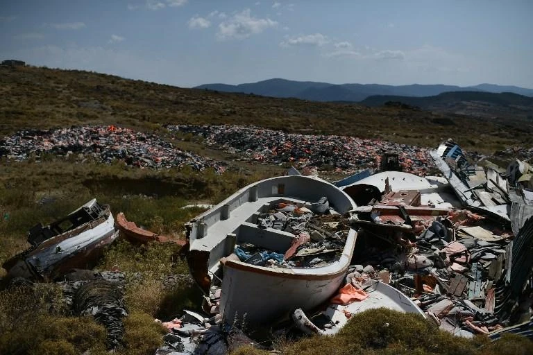 The authorities found the migrants between island of Samothraki and Alexandroupoli port. Above, pictured are boat wreckages and thousands of life jackets left by refugees in a dump in Lesbos island in 2018. (AFP/File)