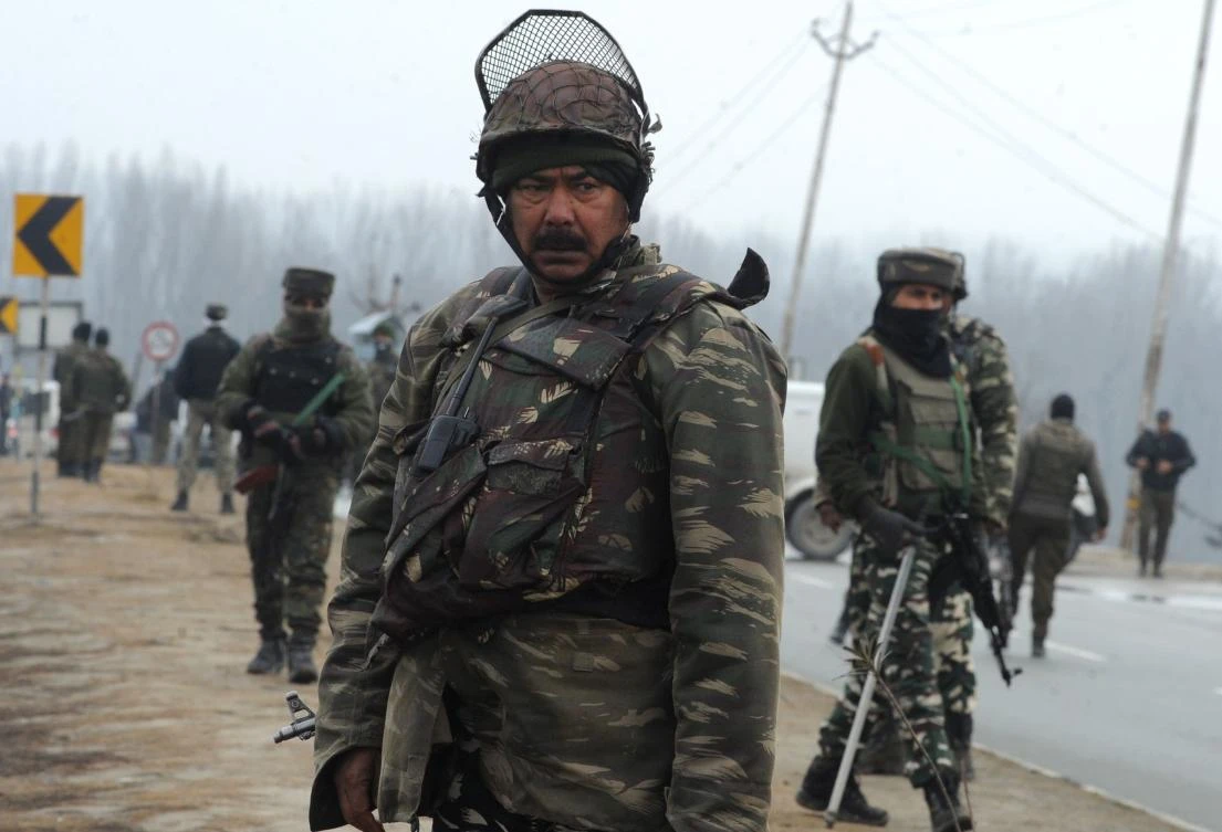 Security forces stand guard along the Jammu-Srinagar highway in the Lethpora area of Kashmir, a day after a suicide attack on paramilitary personnel on February 14 which killed at least 40 people. (AFP)